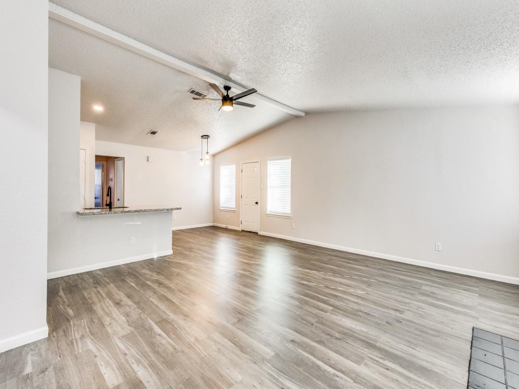 7457 Tiffany Meadows Lane Fort Worth, TX 76140 - Photo 8 of 18 an empty room with wooden floor and windows