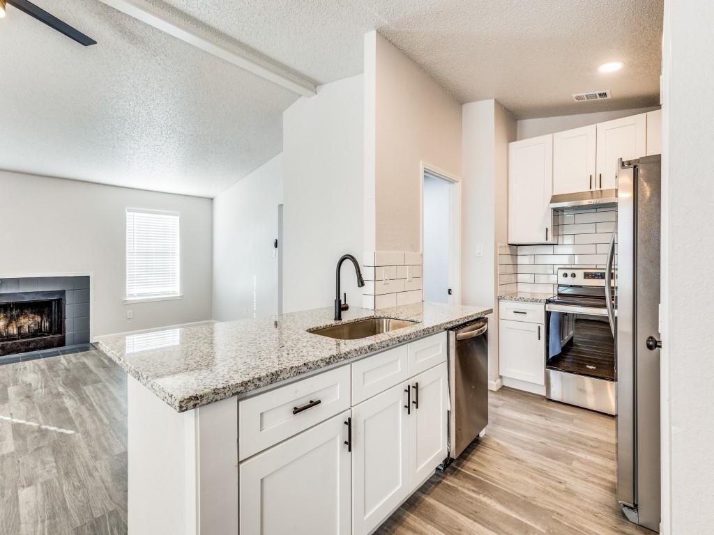 7457 Tiffany Meadows Lane Fort Worth, TX 76140 - Photo 18 of 18 a kitchen with granite countertop a sink and a stove