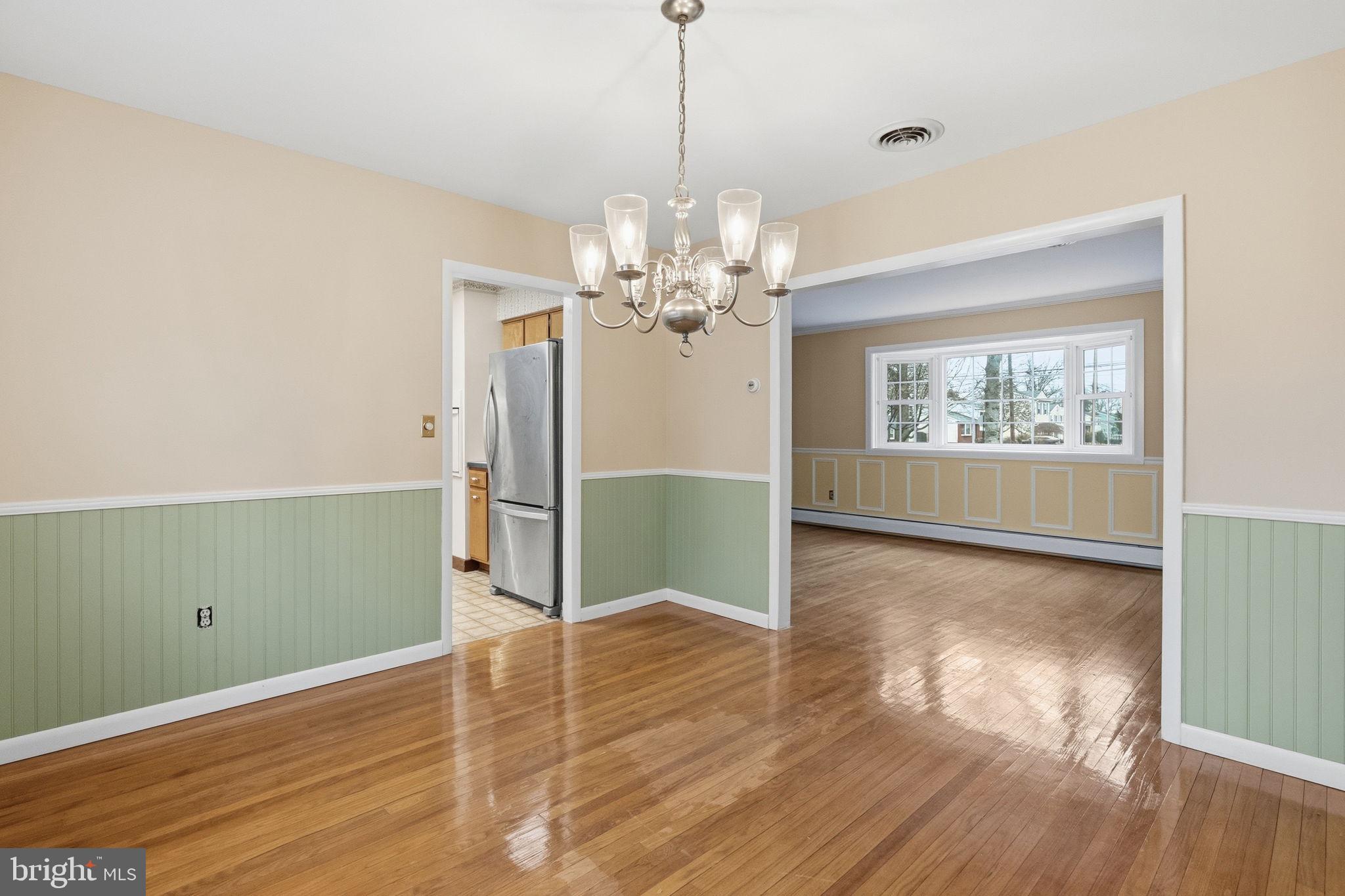 416 Oak Park Road Hatfield, PA 19440 - Photo 14 of 39 a view of a room with wooden floor chandelier and windows