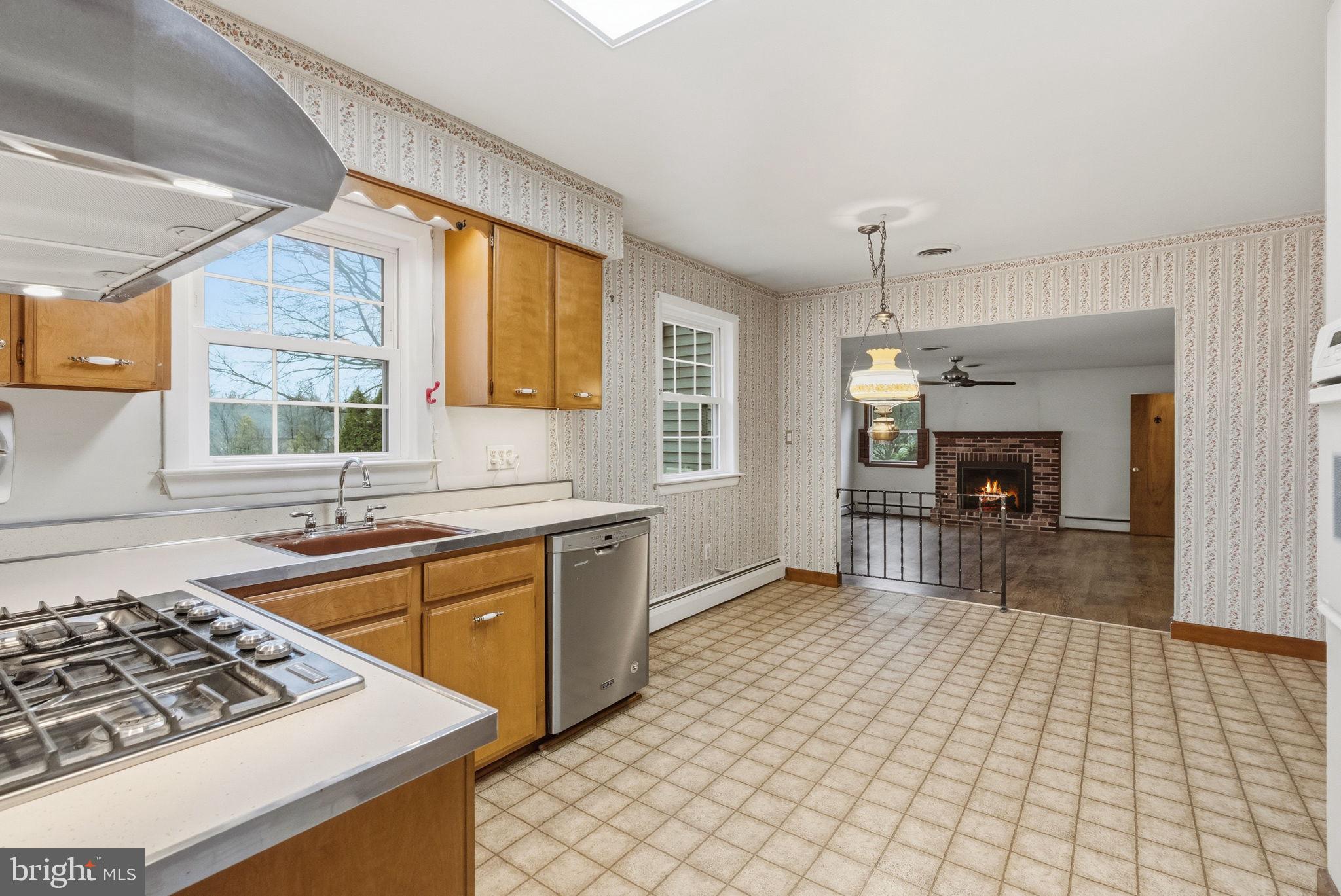 416 Oak Park Road Hatfield, PA 19440 - Photo 15 of 39 a kitchen with stainless steel appliances granite countertop a sink stove and refrigerator