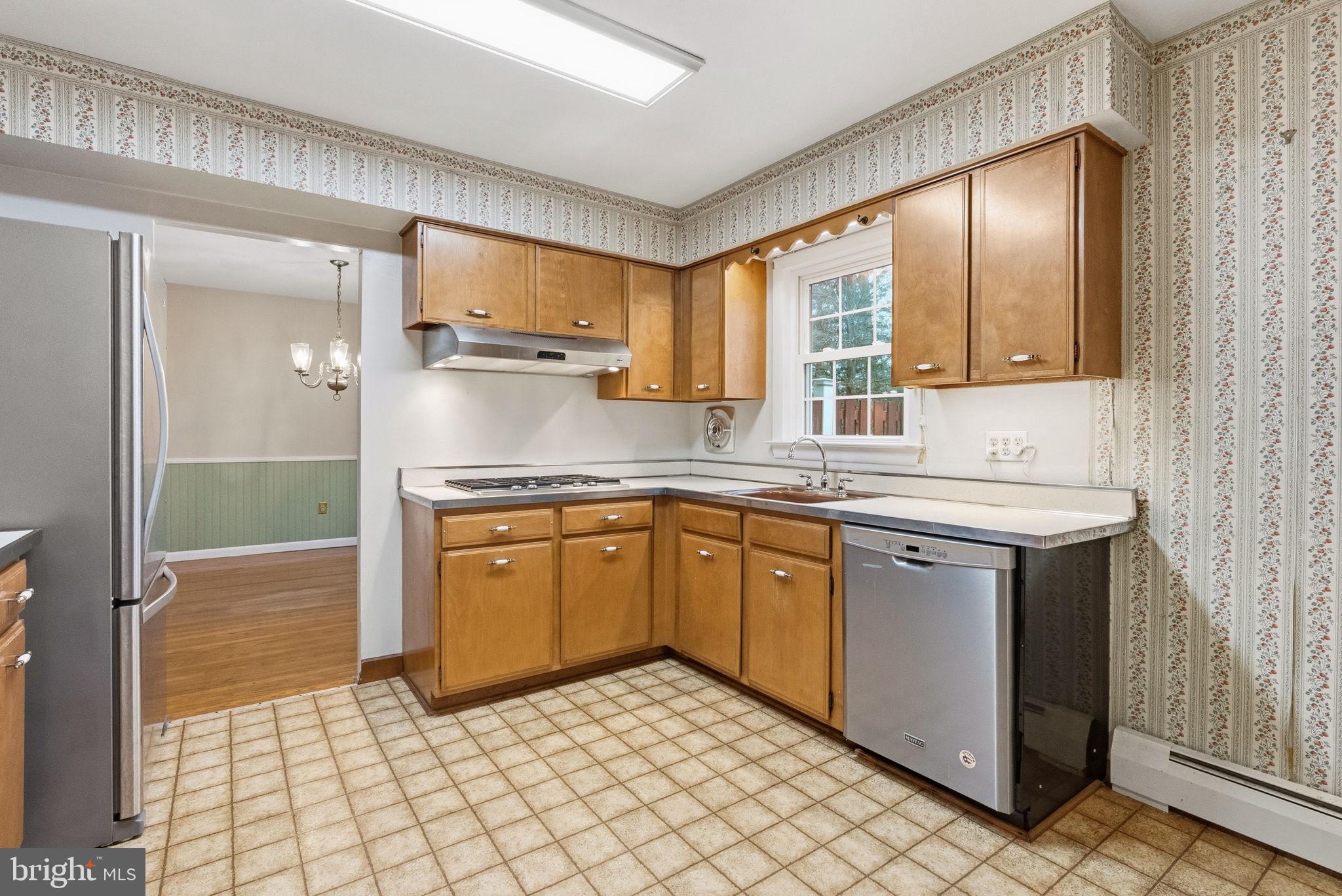 416 Oak Park Road Hatfield, PA 19440 - Photo 16 of 39 a kitchen with stainless steel appliances granite countertop a sink stove and refrigerator
