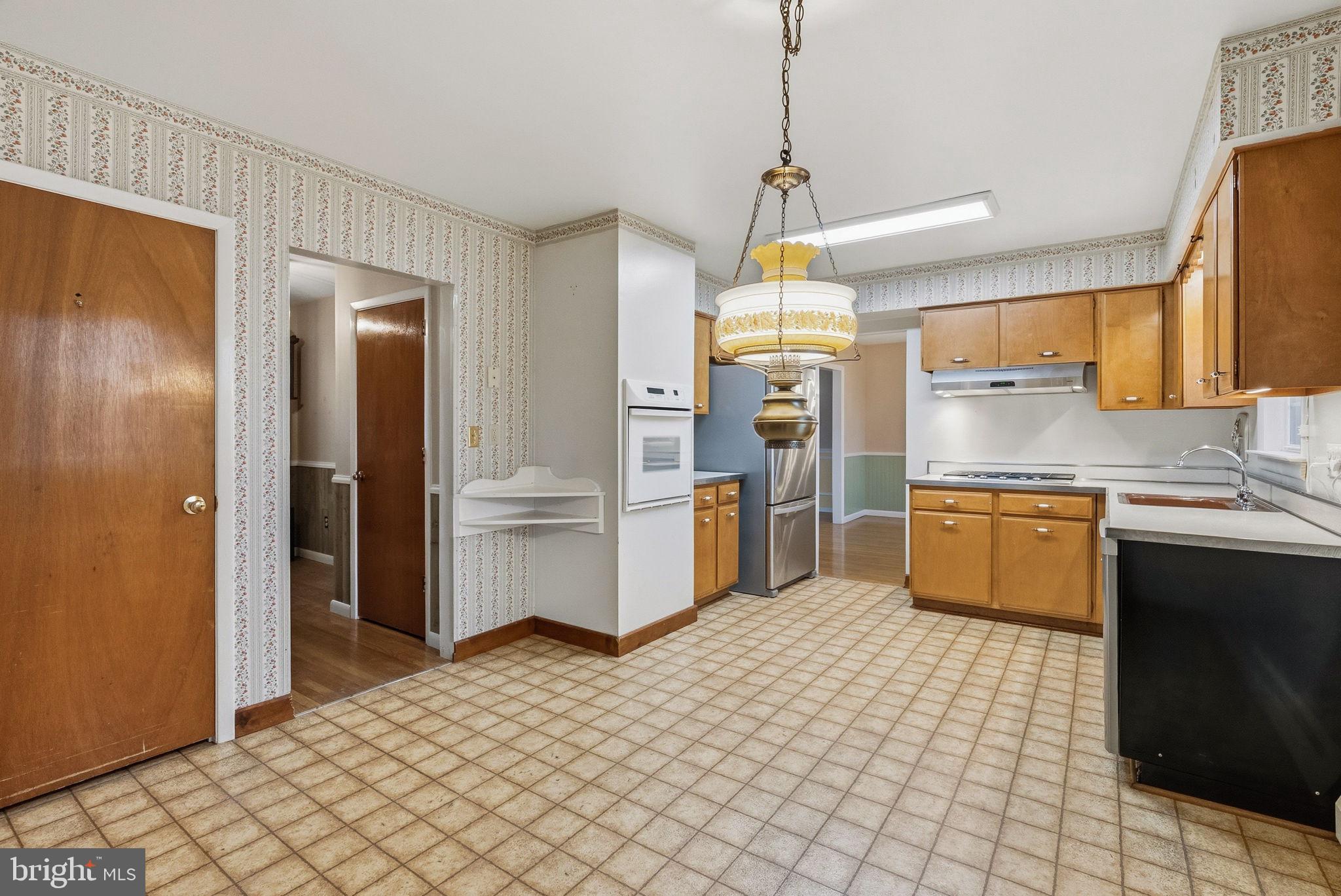 416 Oak Park Road Hatfield, PA 19440 - Photo 17 of 39 a kitchen with stainless steel appliances a sink and a refrigerator