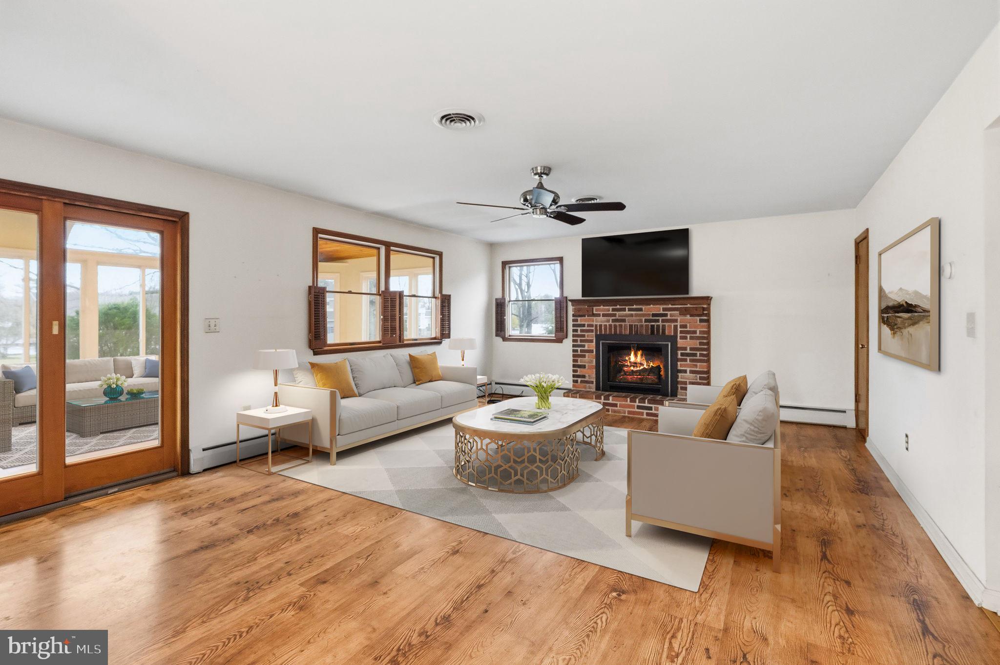 416 Oak Park Road Hatfield, PA 19440 - Photo 18 of 39 a living room with furniture a flat screen tv and a fireplace