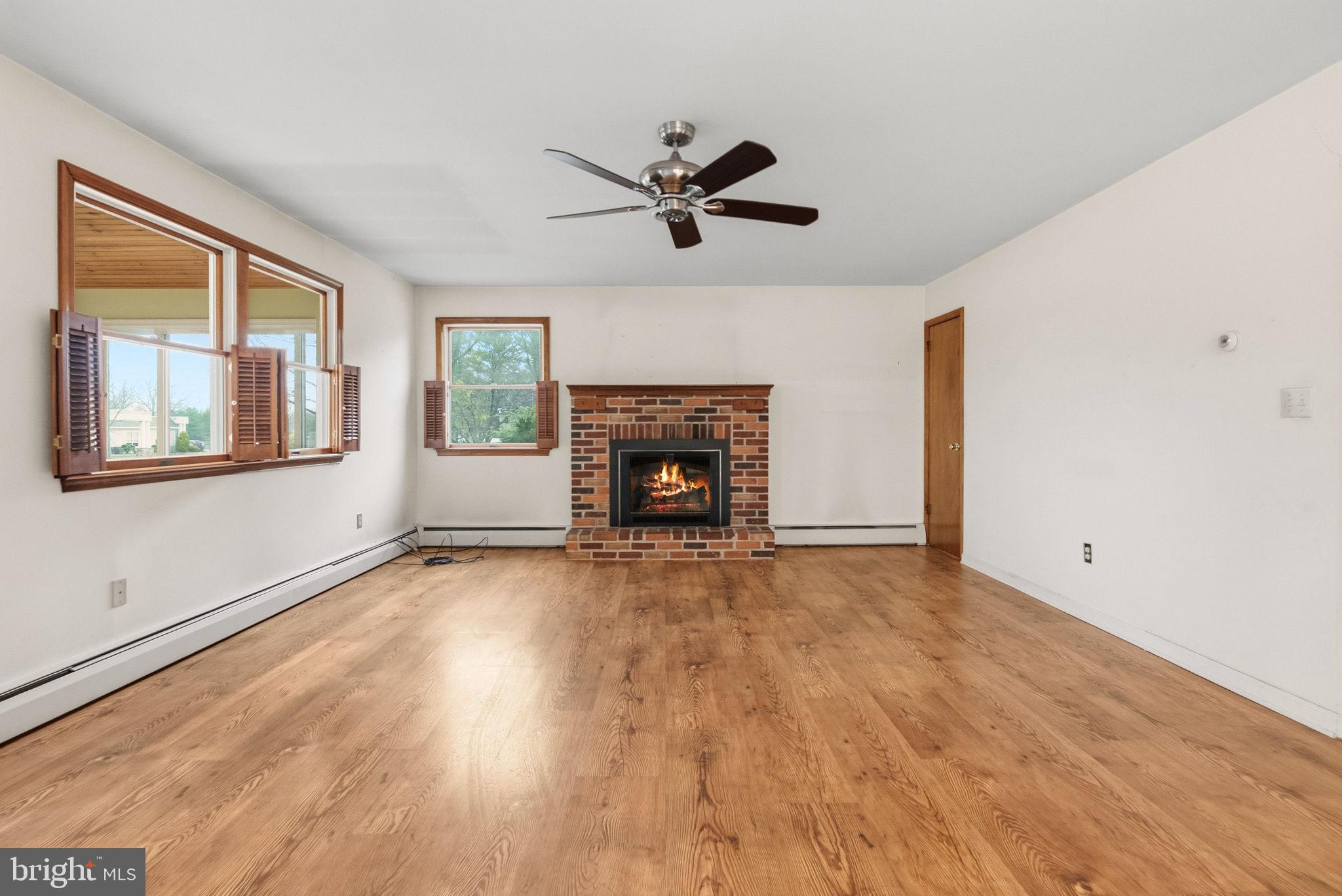 416 Oak Park Road Hatfield, PA 19440 - Photo 19 of 39 a view of a livingroom with a fireplace a ceiling fan and window