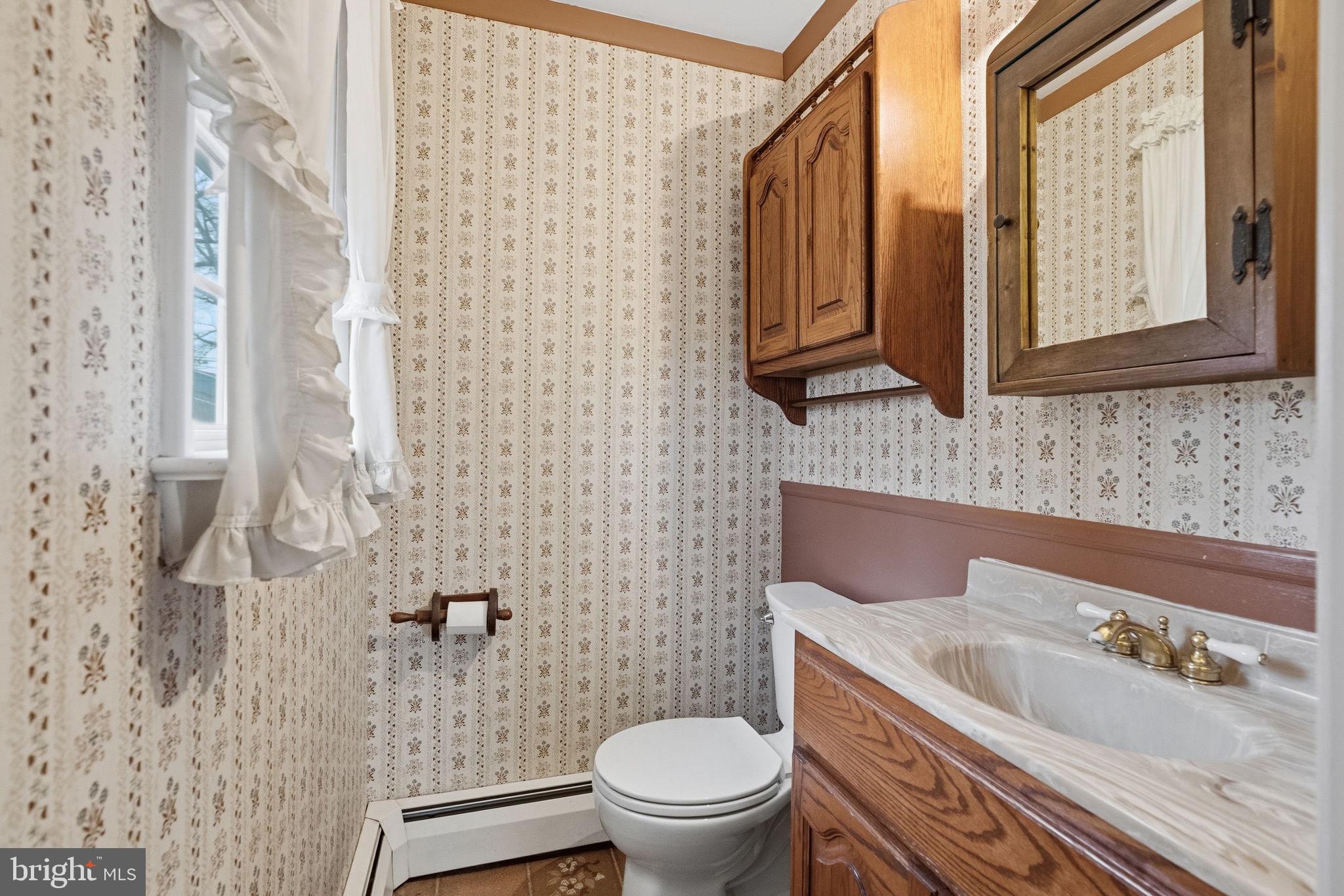 416 Oak Park Road Hatfield, PA 19440 - Photo 20 of 39 a bathroom with a sink a toilet and a mirror
