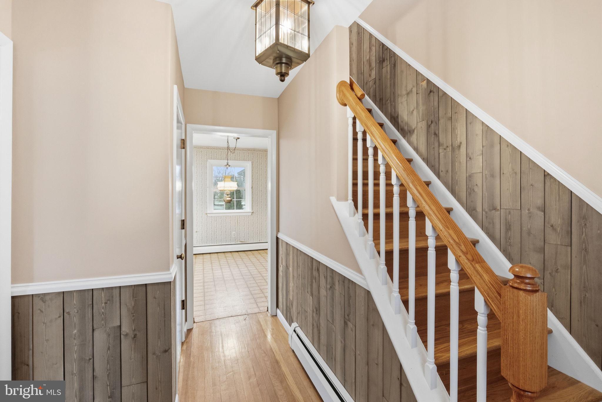 416 Oak Park Road Hatfield, PA 19440 - Photo 7 of 39 a view of a hallway with wooden floor and staircase