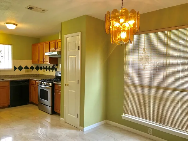 a kitchen with a sink cabinets and stainless steel appliances