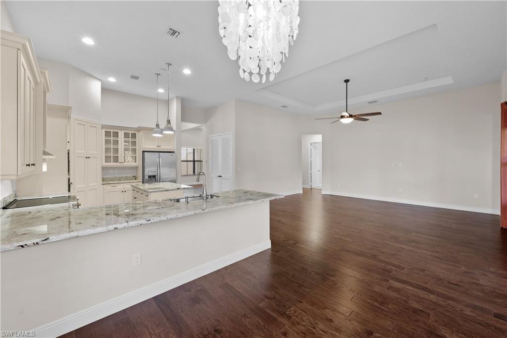 5375 Ferrari Avenue Ave Maria, FL 34142 - Photo 15 of 45 a large kitchen with kitchen island a large island white cabinetry and stainless steel appliances