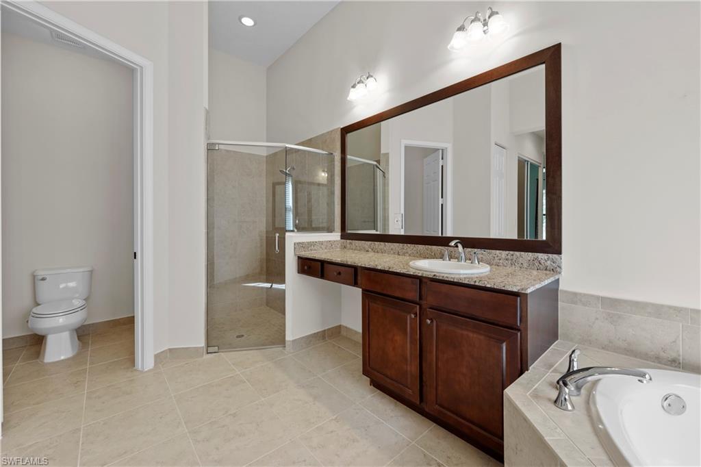 5375 Ferrari Avenue Ave Maria, FL 34142 - Photo 23 of 45 a bathroom with a granite countertop sink and a mirror