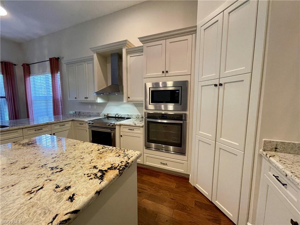 5375 Ferrari Avenue Ave Maria, FL 34142 - Photo 10 of 45 a kitchen with stainless steel appliances a stove a sink and a refrigerator