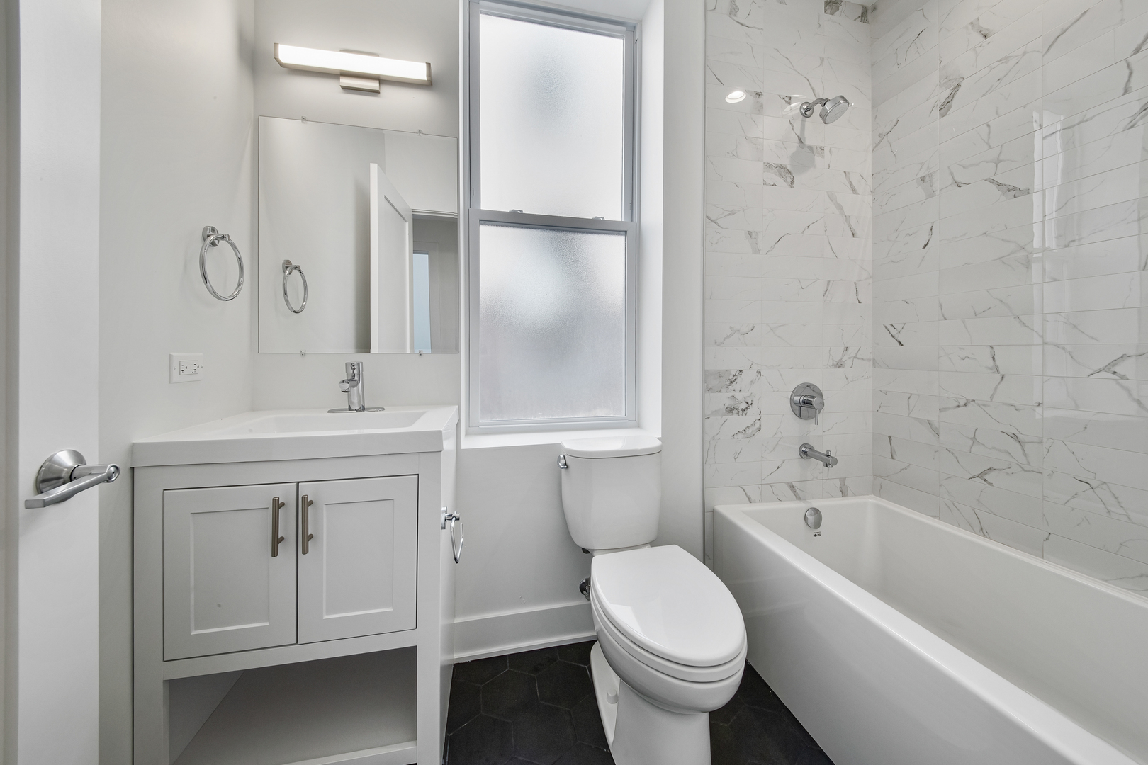 2316 West Augusta Boulevard, Unit 2R Chicago, IL 60622 - Photo 3 of 5 a bathroom with a sink toilet and shower