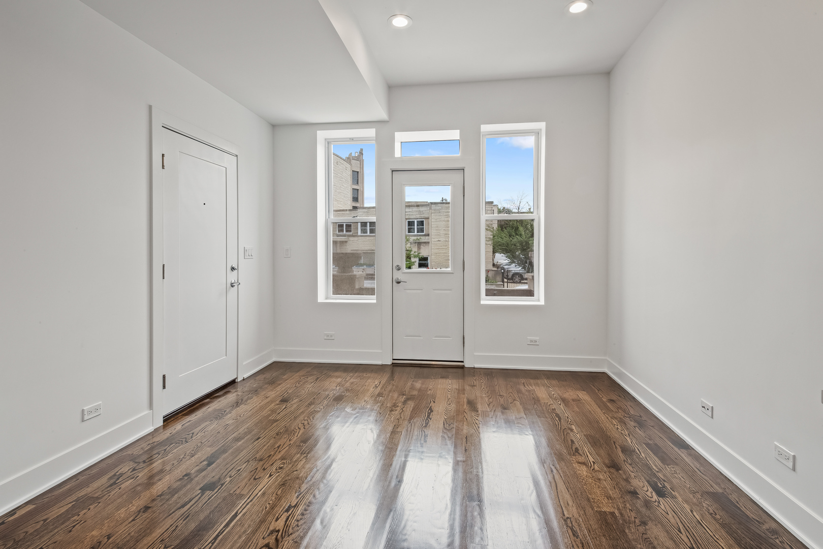 2316 West Augusta Boulevard, Unit 2R Chicago, IL 60622 - Photo 5 of 5 an empty room with wooden floor and windows