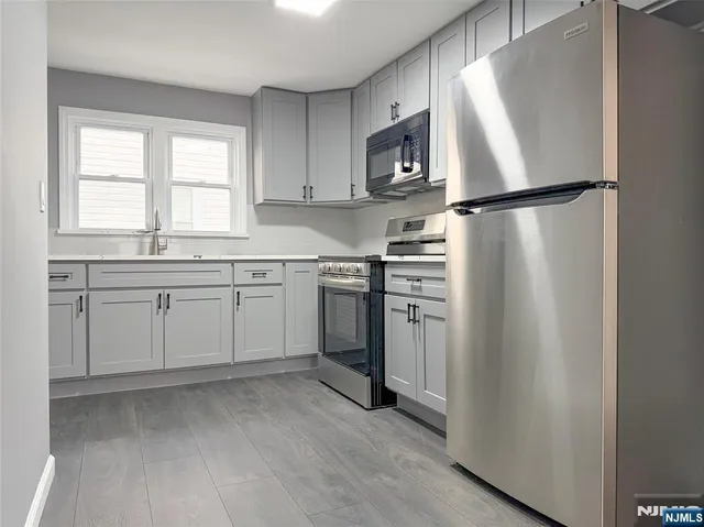 a kitchen with white cabinets and white appliances