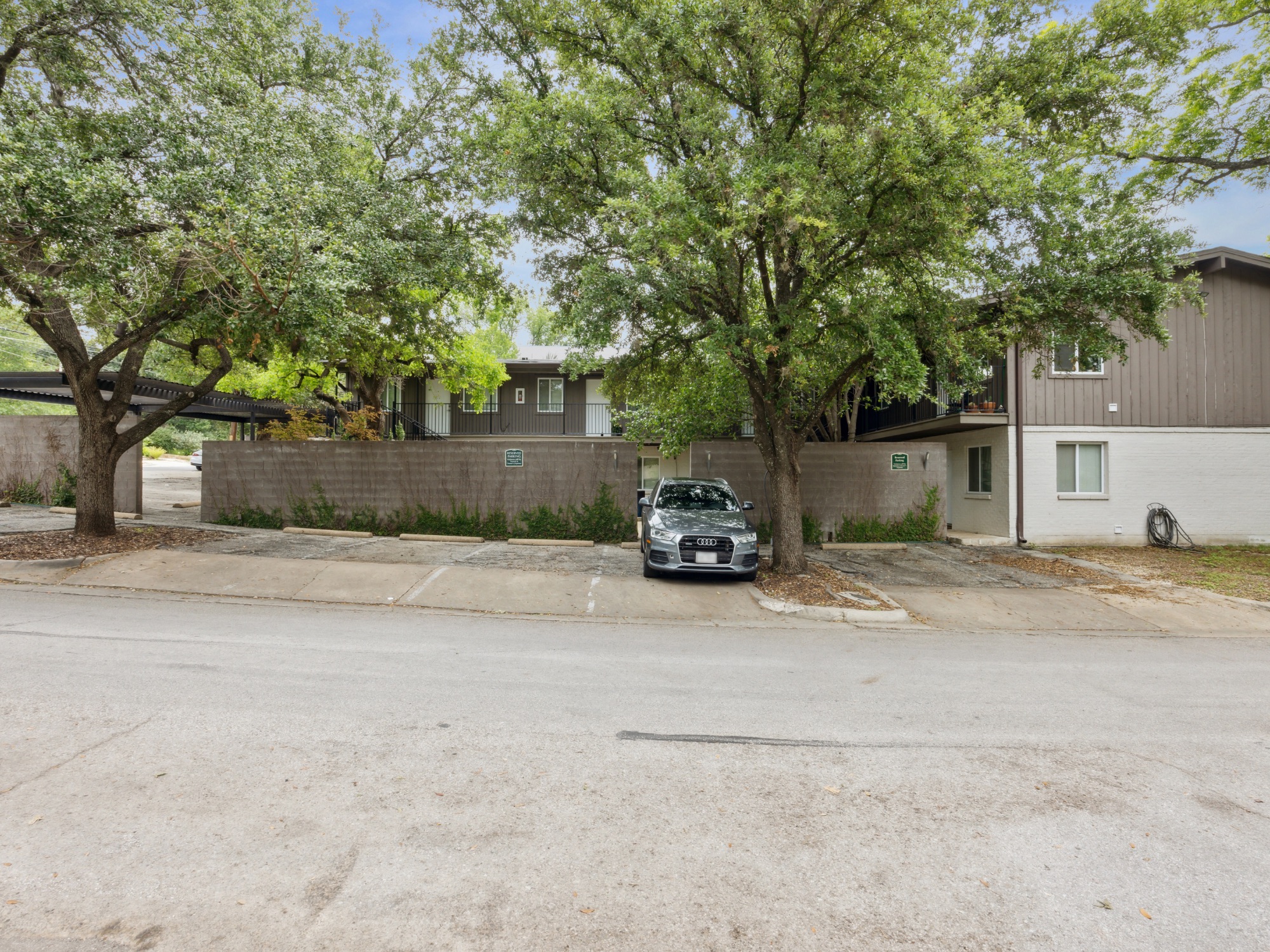 1503 West 9th Street, Unit 204 Austin, TX 78703 - Photo 18 of 21 Multi-level residential building featuring a brown siding upper level and a white lower level