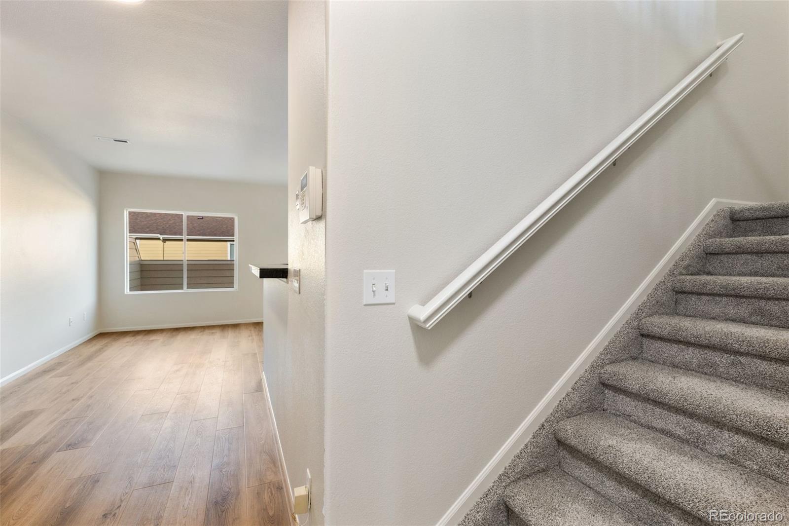 5645 Saint Patrick View Colorado Springs, CO 80923 - Photo 12 of 33 a view of entryway and hall with wooden floor