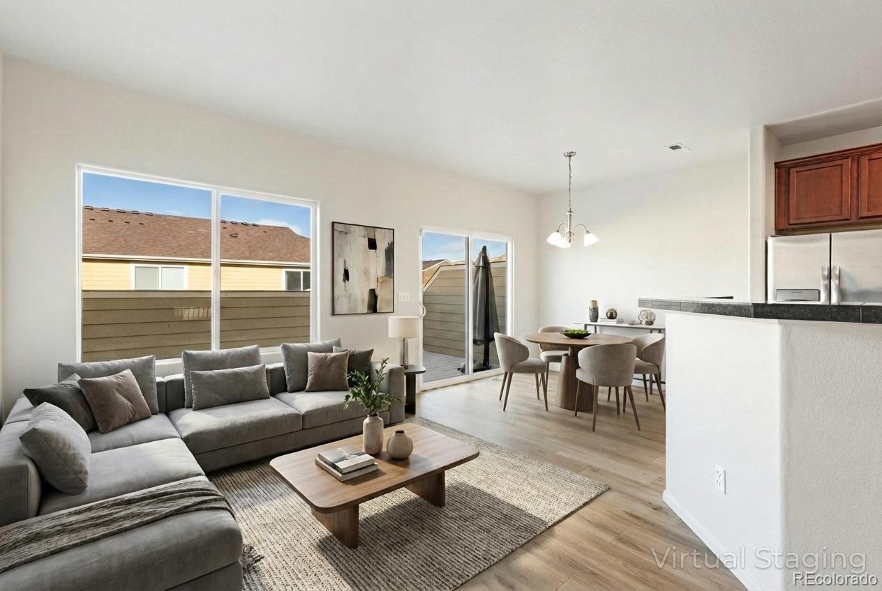 5645 Saint Patrick View Colorado Springs, CO 80923 - Photo 15 of 33 a living room with furniture kitchen view and a large window
