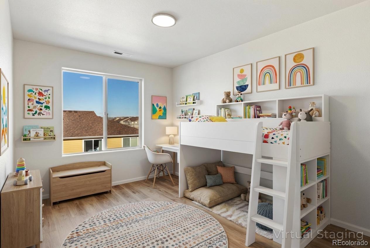 5645 Saint Patrick View Colorado Springs, CO 80923 - Photo 30 of 33 a bedroom with a bed and a couch