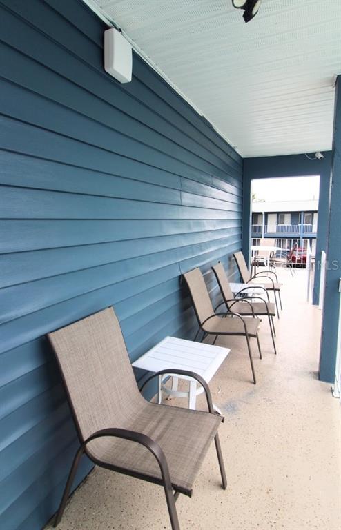 3001 Bee Ridge Road, Unit 111 Sarasota, FL 34239 - Photo 15 of 20 a view of a patio with table and chairs with wooden floor and fence