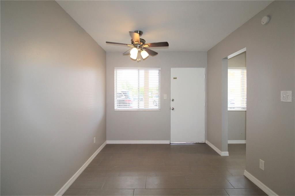 3001 Bee Ridge Road, Unit 111 Sarasota, FL 34239 - Photo 4 of 20 an empty room with windows and fan