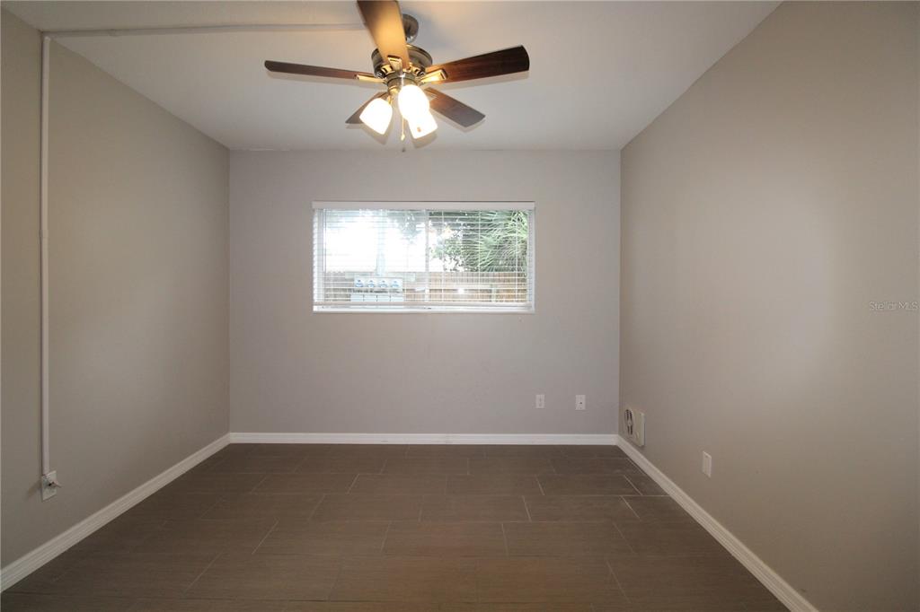 3001 Bee Ridge Road, Unit 111 Sarasota, FL 34239 - Photo 7 of 20 an empty room with windows and fan