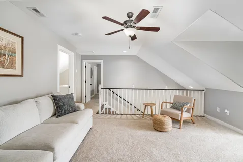 a living room with furniture and white walls