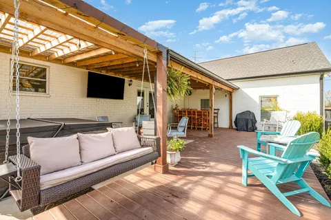 a outdoor living space with patio furniture and a flat screen tv