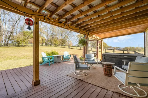 a view of a swimming pool with furniture and wooden floor