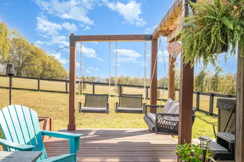 a view of a balcony with floor to ceiling windows wooden floor and outdoor space
