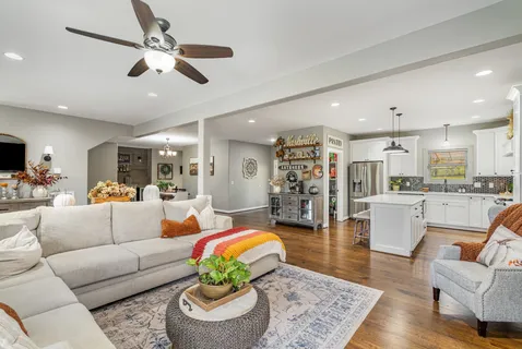 a living room with furniture and kitchen view