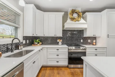 a kitchen with cabinets appliances and a sink