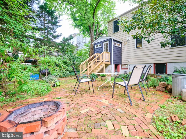a backyard of a house with table and chairs