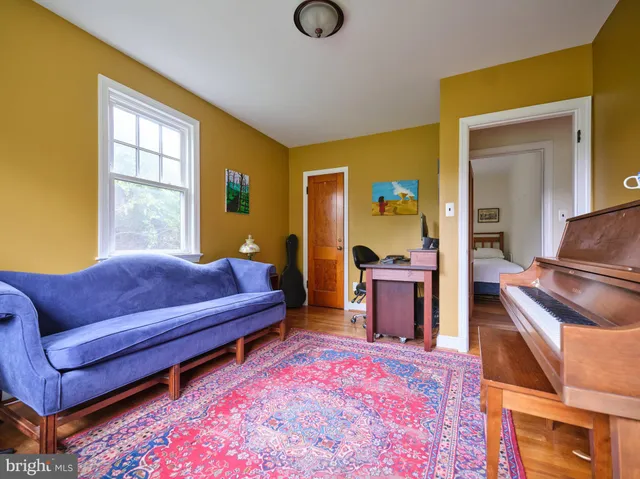 a bedroom with furniture and a wooden floor