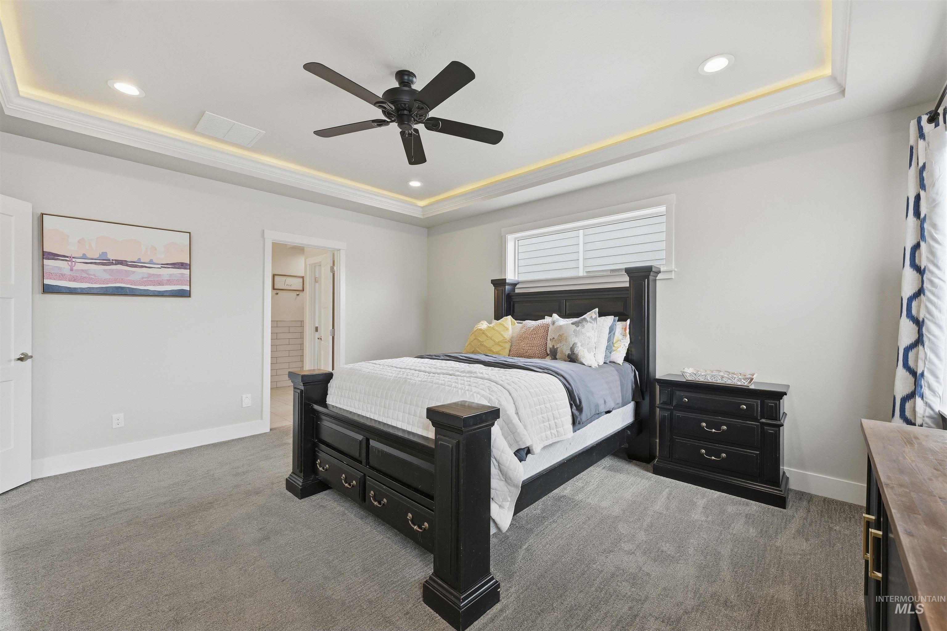2229 East Grayson Street Meridian, ID 83642 - Photo 20 of 40 Bedroom featuring a raised ceiling, dark carpet, a ceiling fan, recessed lighting, and connected bathroom