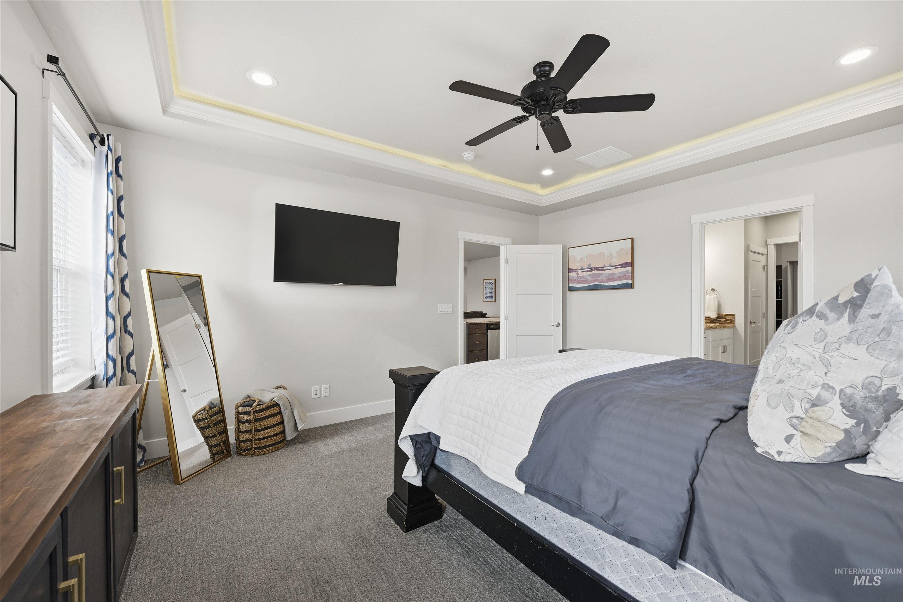 2229 East Grayson Street Meridian, ID 83642 - Photo 21 of 40 Bedroom with recessed lighting, dark carpet, ceiling fan, a tray ceiling, and ensuite bathroom