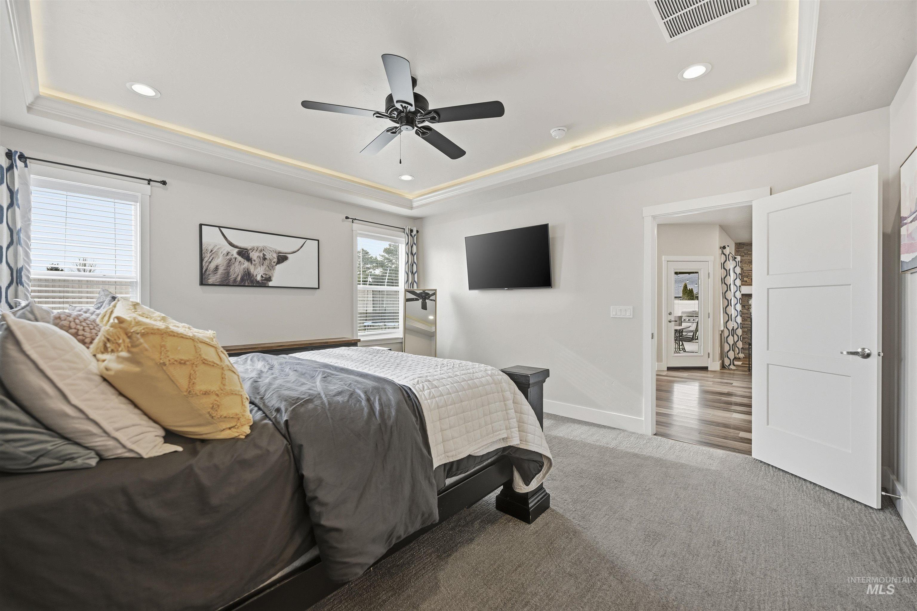 2229 East Grayson Street Meridian, ID 83642 - Photo 22 of 40 Carpeted bedroom with a tray ceiling, recessed lighting, and ceiling fan