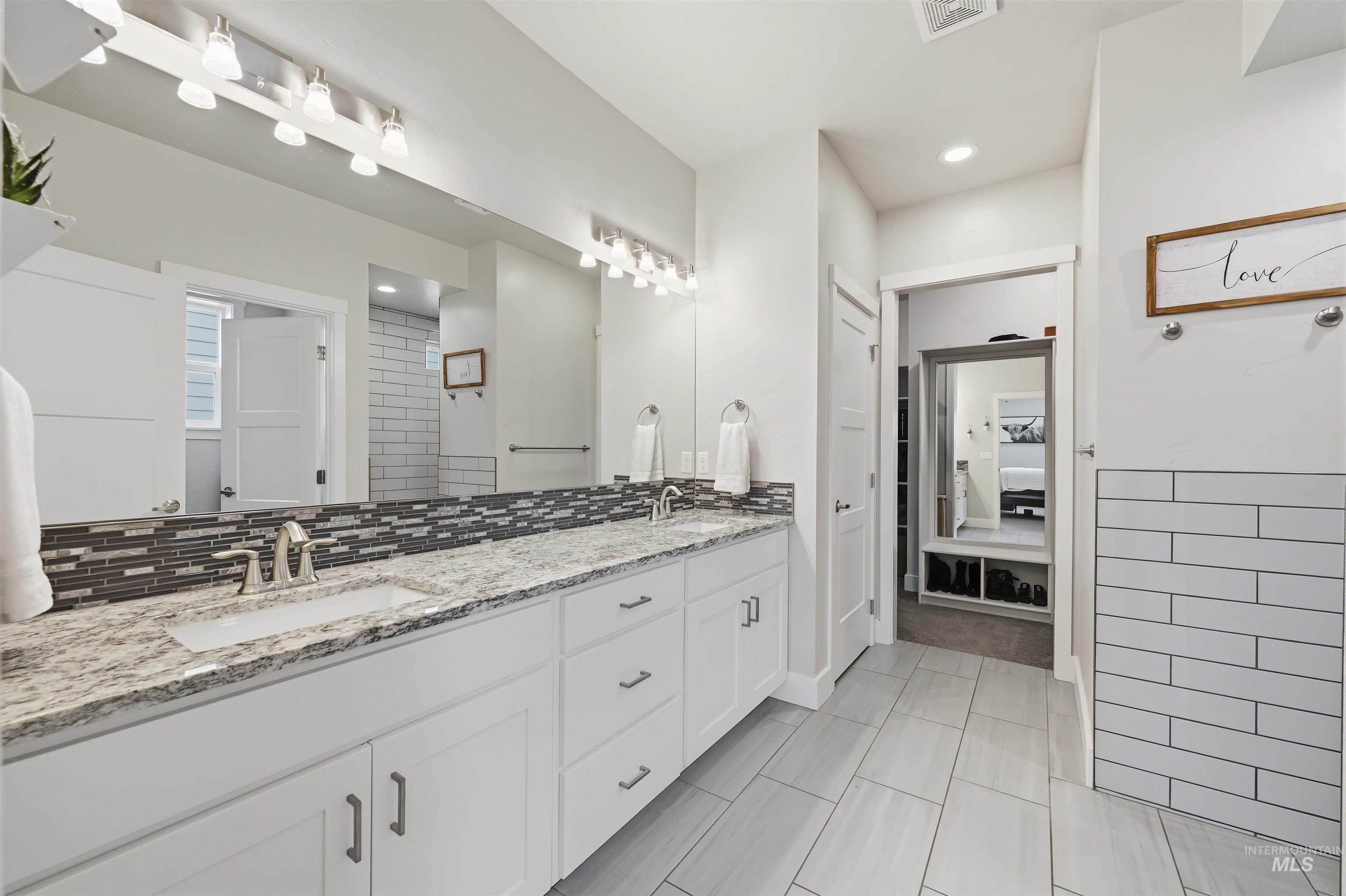 2229 East Grayson Street Meridian, ID 83642 - Photo 23 of 40 Bathroom featuring double vanity, ensuite bath, backsplash, light tile patterned flooring, and recessed lighting