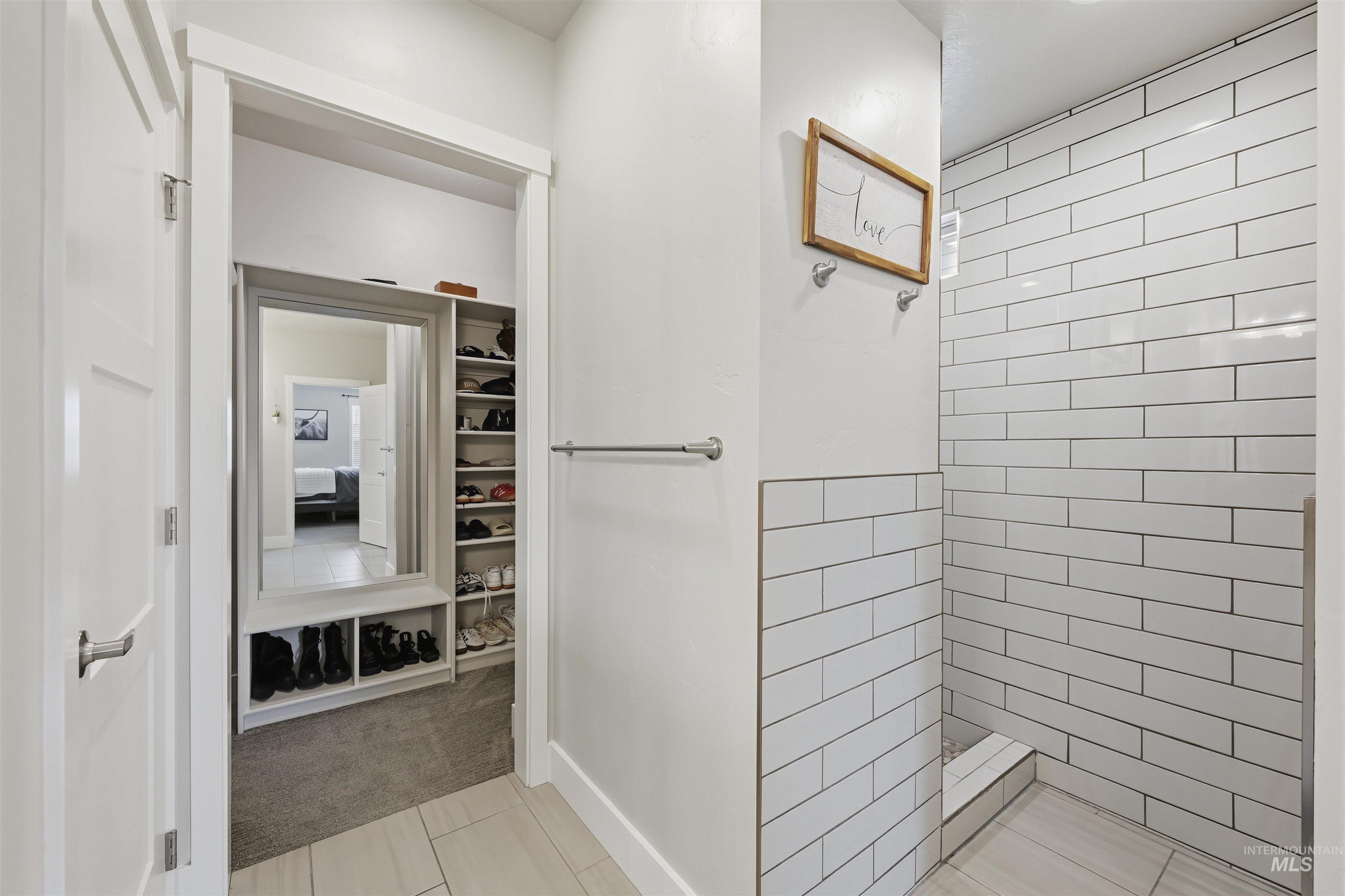 2229 East Grayson Street Meridian, ID 83642 - Photo 24 of 40 Full bathroom with walk in shower, light carpet, light tile patterned floors, and a spacious closet