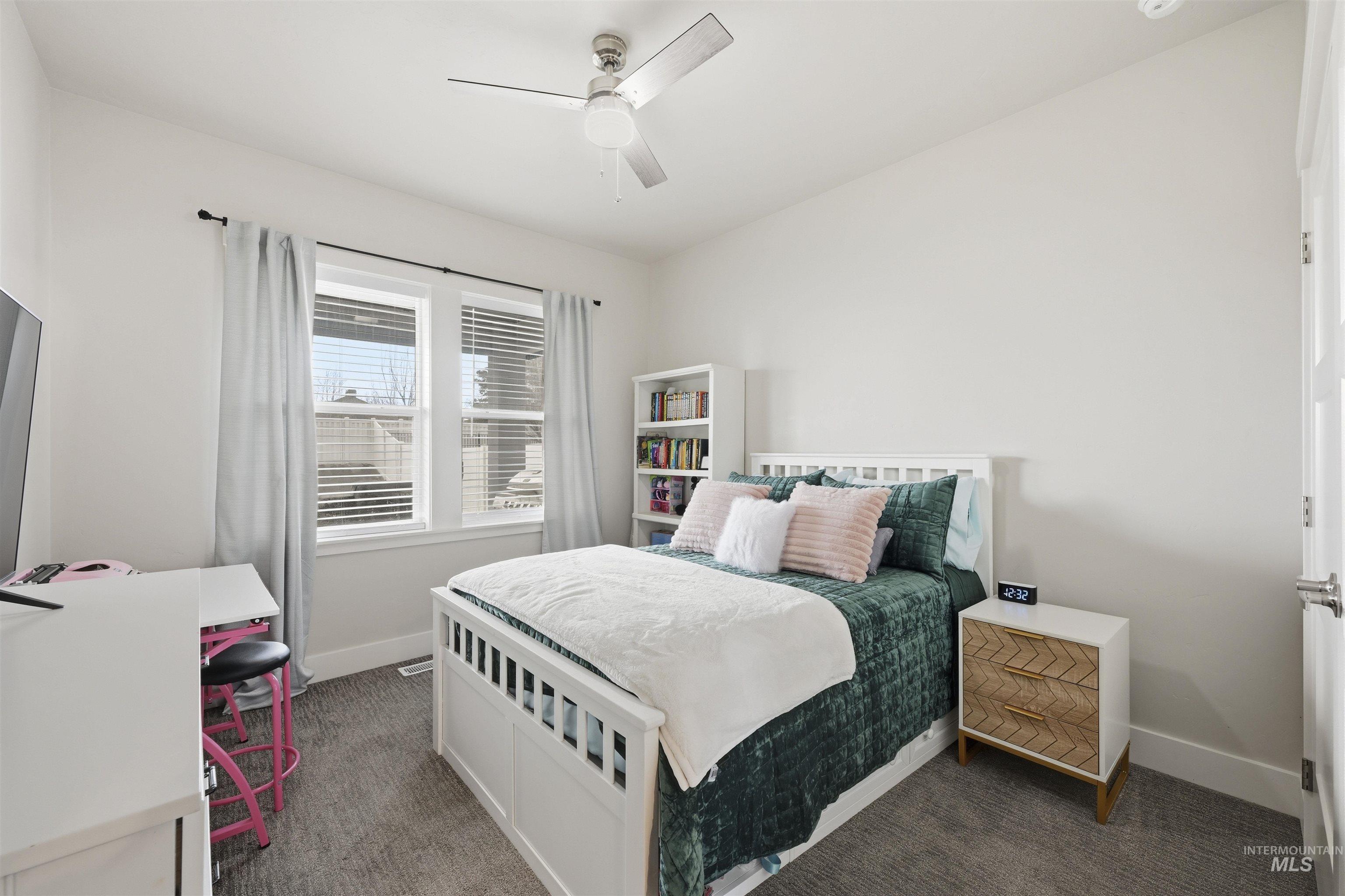 2229 East Grayson Street Meridian, ID 83642 - Photo 27 of 40 Carpeted bedroom featuring baseboards and a ceiling fan