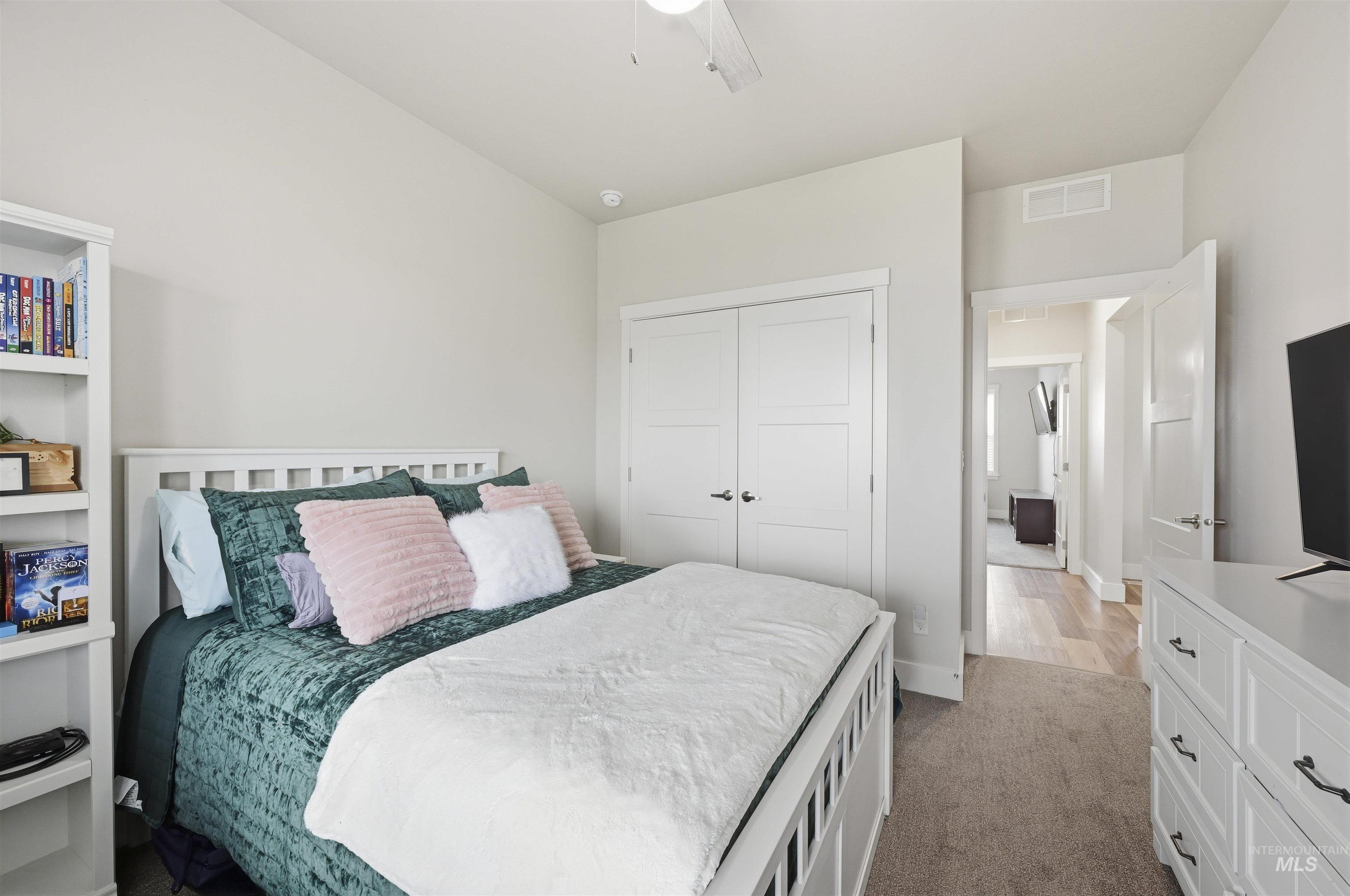 2229 East Grayson Street Meridian, ID 83642 - Photo 28 of 40 Bedroom featuring a closet, light colored carpet, and ceiling fan