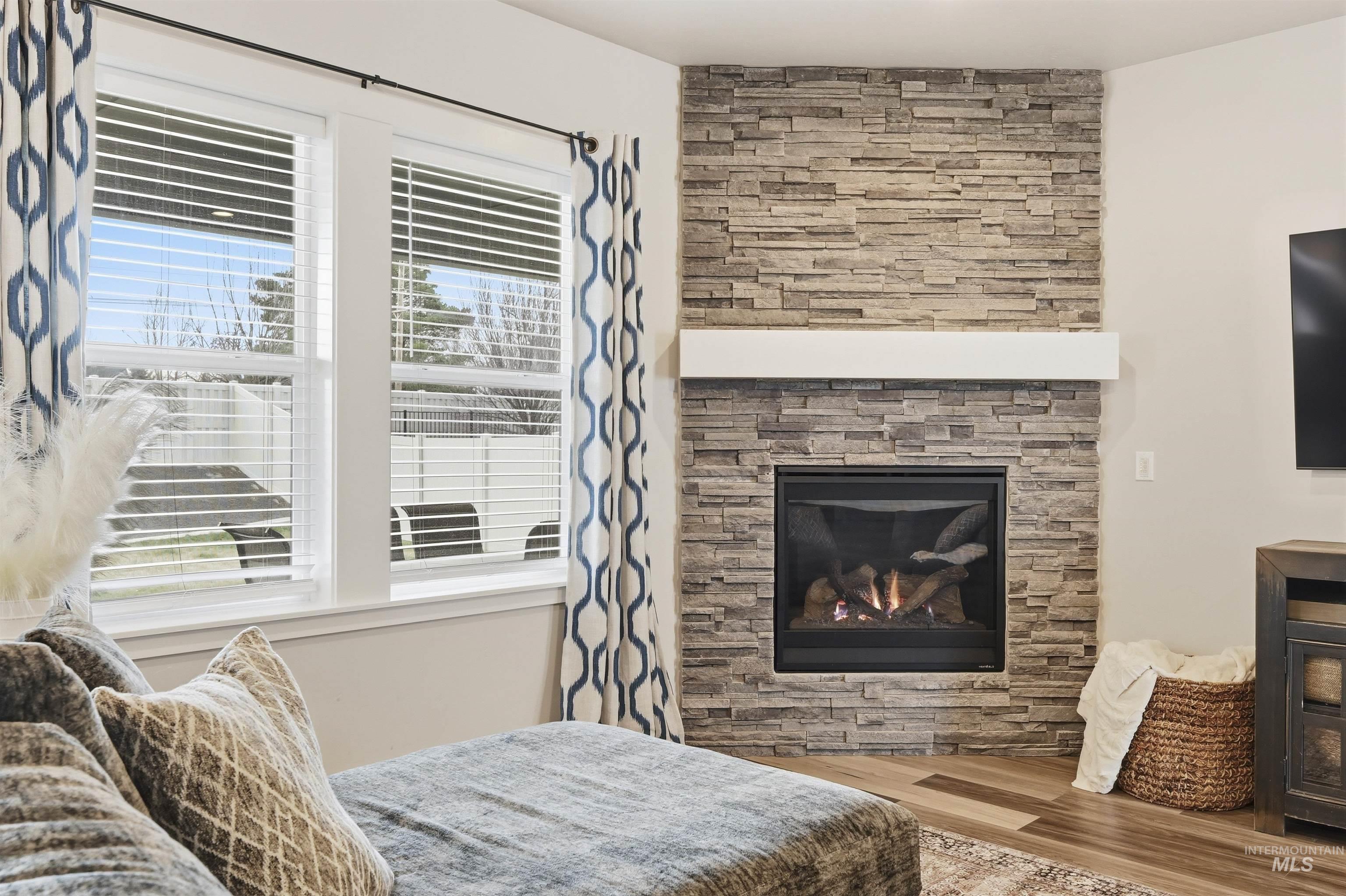 2229 East Grayson Street Meridian, ID 83642 - Photo 7 of 40 Bedroom featuring wood finished floors and a fireplace