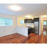 a kitchen with stainless steel appliances granite countertop a refrigerator and a stove top oven