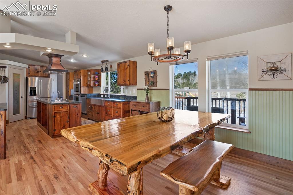 63 Bear Claw Trail Divide, CO 80814 - Photo 11 of 28 a view of a dining room and livingroom with furniture wooden floor a chandelier