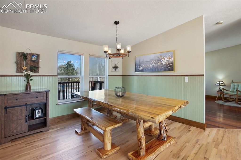 63 Bear Claw Trail Divide, CO 80814 - Photo 12 of 28 a view of a dining room with furniture and wooden floor