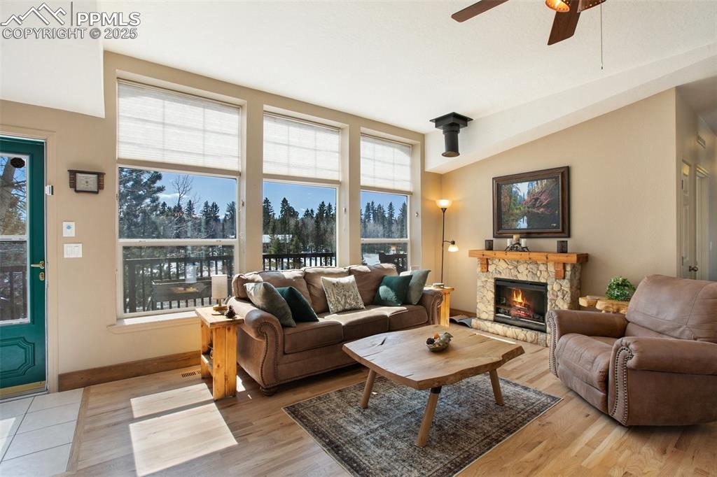 63 Bear Claw Trail Divide, CO 80814 - Photo 15 of 28 a living room with furniture a fireplace and a table