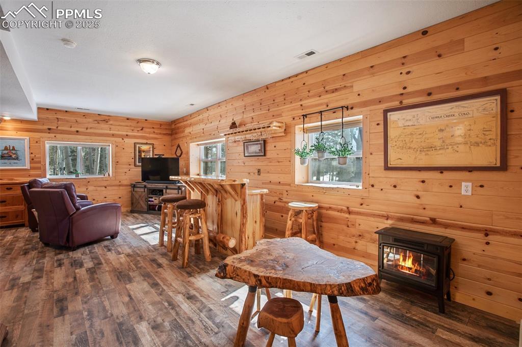 63 Bear Claw Trail Divide, CO 80814 - Photo 21 of 28 a kitchen with stainless steel appliances granite countertop a stove a refrigerator a sink a dining table and chairs with wooden floor