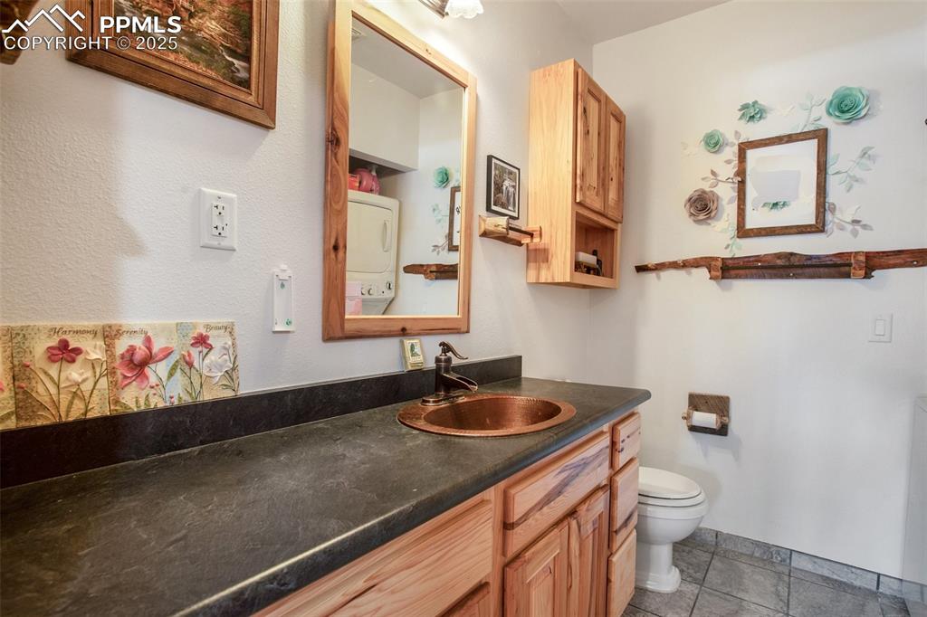 63 Bear Claw Trail Divide, CO 80814 - Photo 23 of 28 a bathroom with a sink a vanity and a toilet
