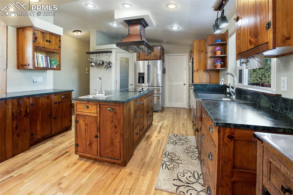63 Bear Claw Trail Divide, CO 80814 - Photo 8 of 28 a kitchen with stainless steel appliances granite countertop a sink a counter space and cabinets