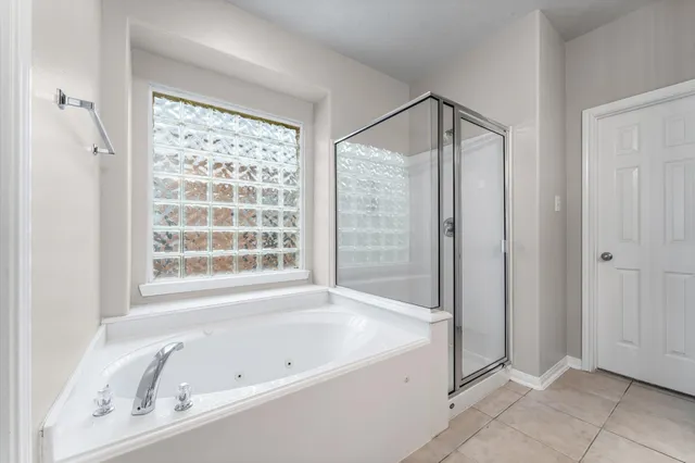 a bathroom with a bathtub and a shower