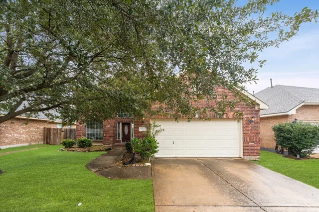 a front view of a house with a yard and a garage