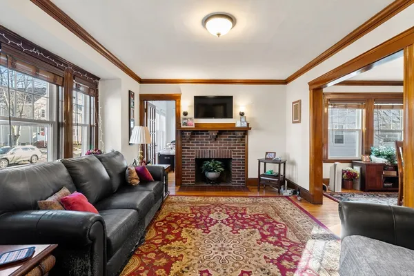 a living room with furniture a flat screen tv and a fireplace